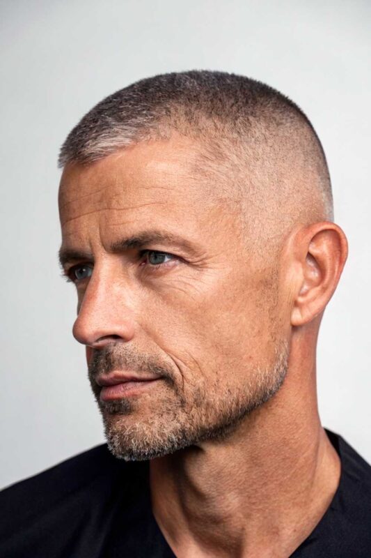 An older man with clean buzz cut hairstyle.