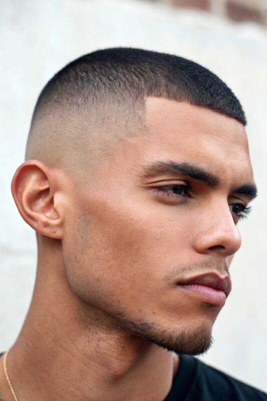 Man with stylish buzz cut featuring a clean fade.