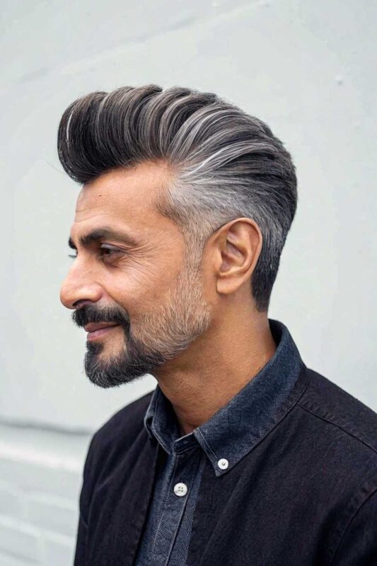 An older man with distinguished pompadour hairstyle.