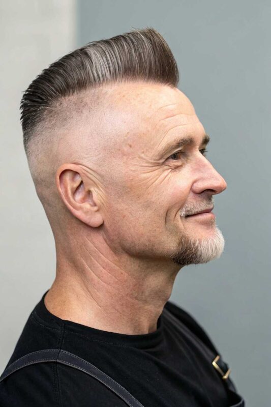 An older man with flat top hairstyle.