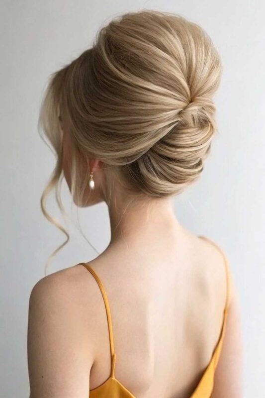 A young woman with loose French twist hairstyle.