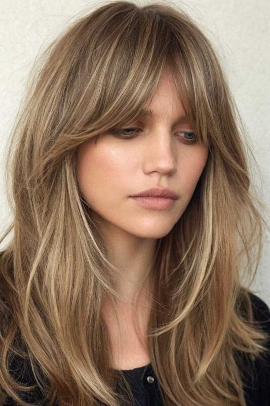A young woman with curtain bangs hairstyle.