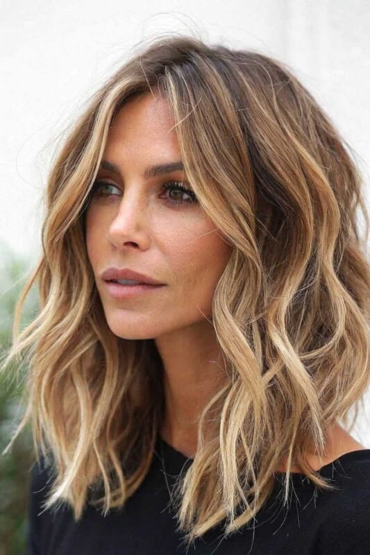 A woman with a textured lob hairstyle.