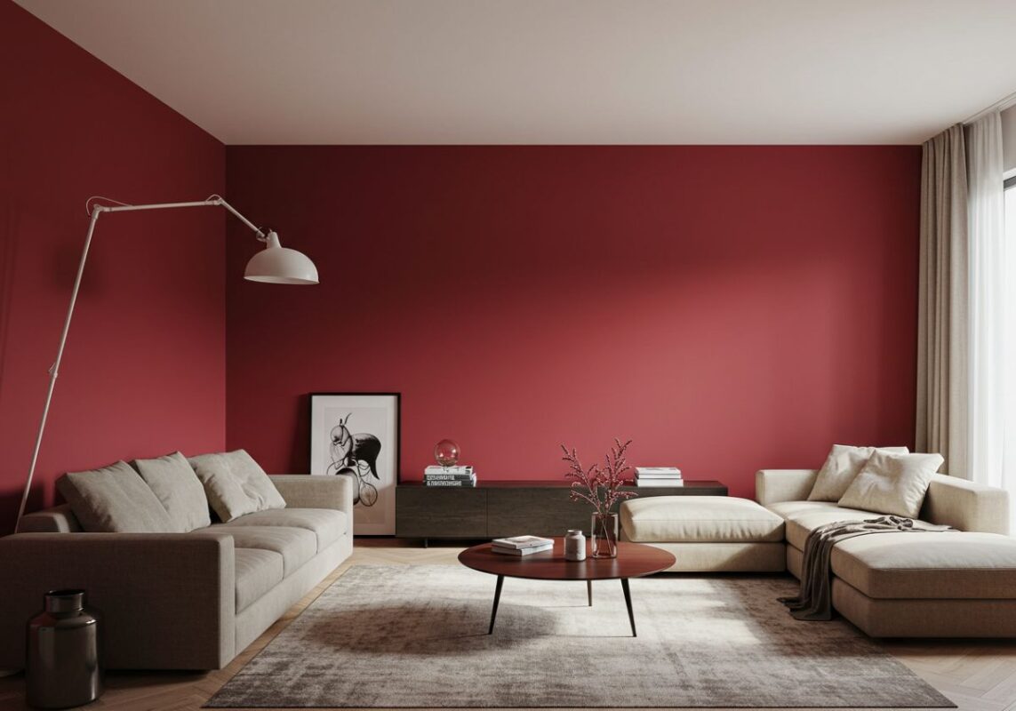 Modern living room with a bold cherry red accent wall, complemented by neutral décor and filled with natural light, creating a vibrant yet balanced space.