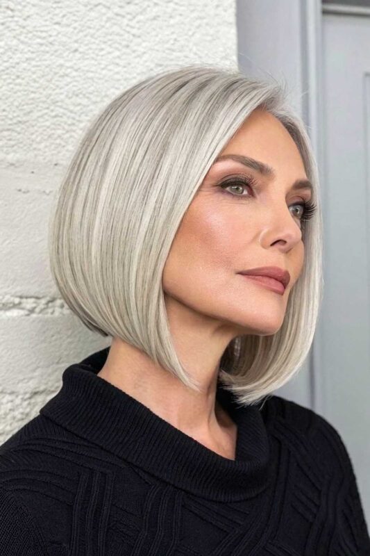 A mature woman with a sleek A-line bob hairstyle.