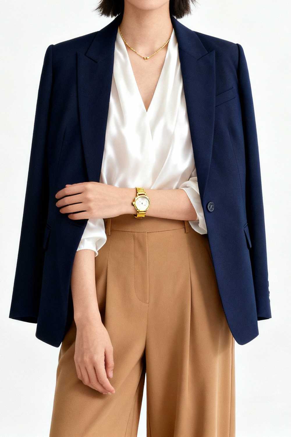 Elegant outfit showing three-color rule with navy blazer, white blouse, and camel trousers