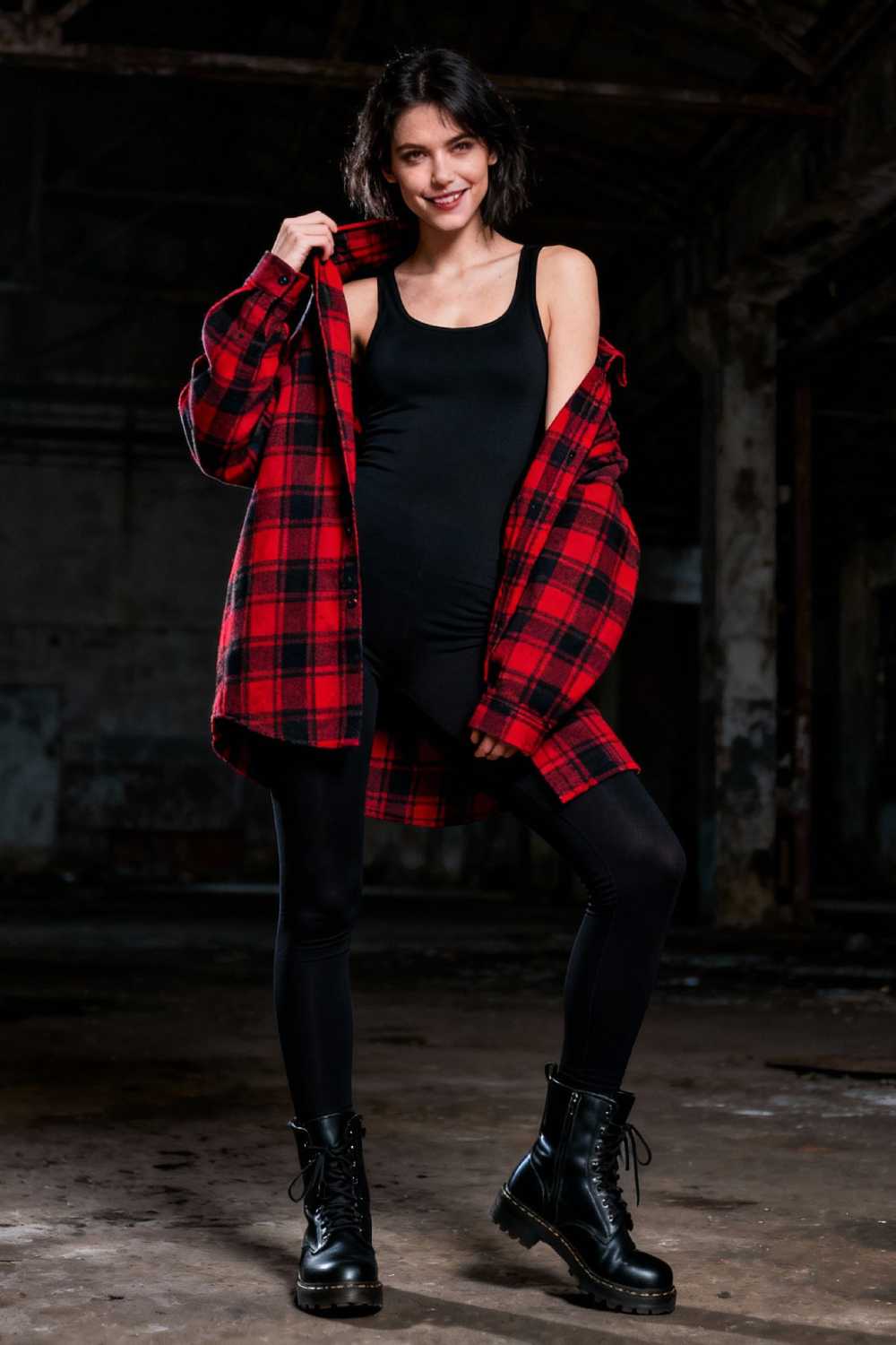 Fashion model in oversized plaid flannel with black basics and combat boots in moody industrial setting